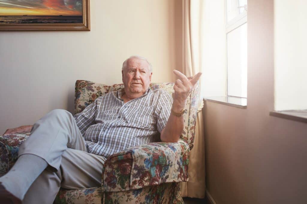 Senior man sitting at assisted living facility